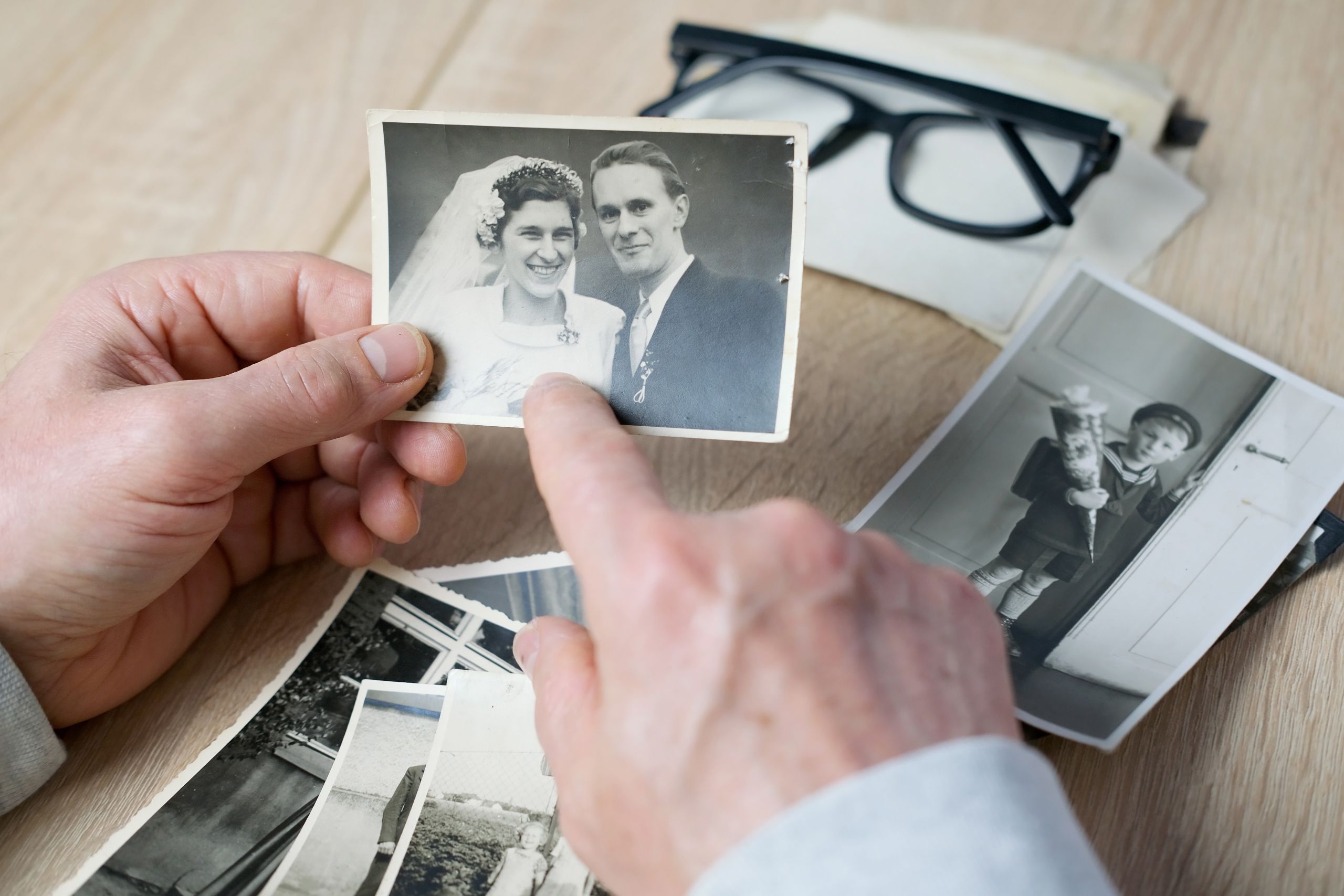 An elderly man looks through his old photographs of 1960-1965